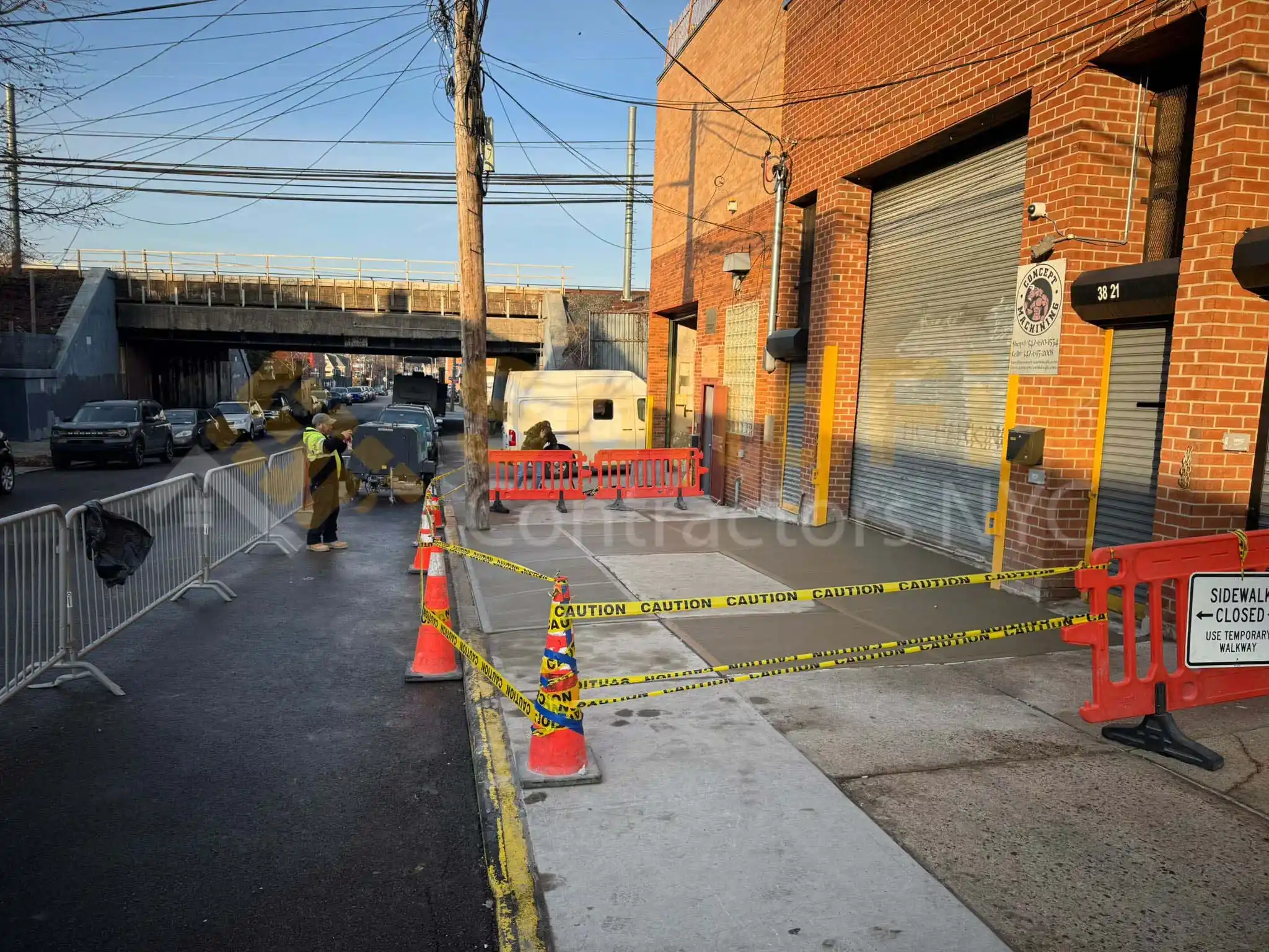 Sidewalk repair in front of a commercial property in NYC, ensuring compliance with DOT regulations and pedestrian safety.